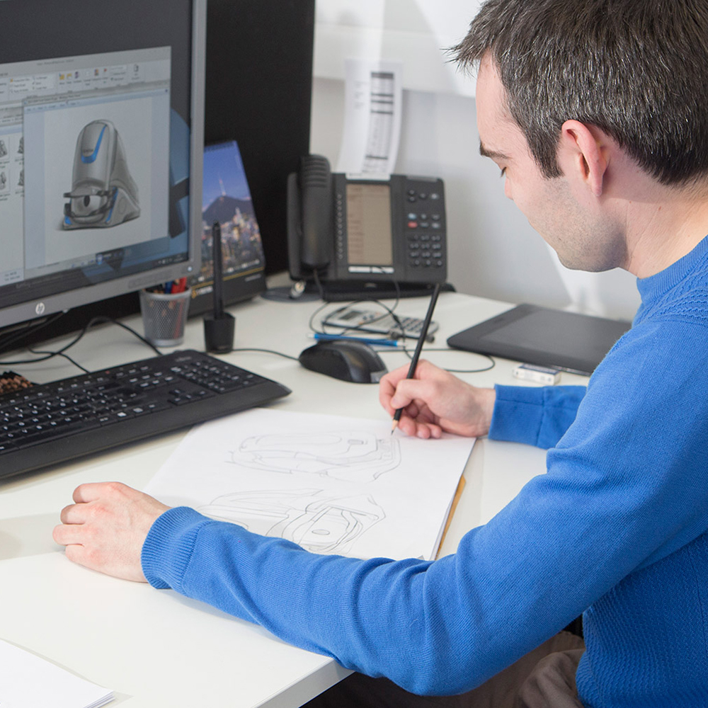Industrial Designer sketching infront of computer with model on screen - Industrial Design Agency - i4 Product Design