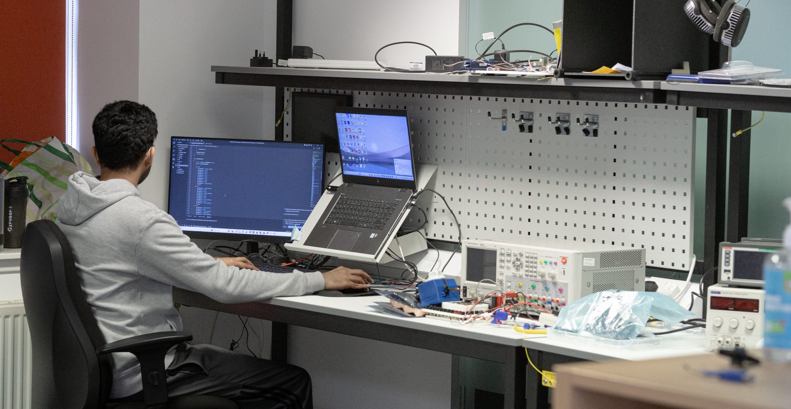 Austin of i4PD working at his laptop on software