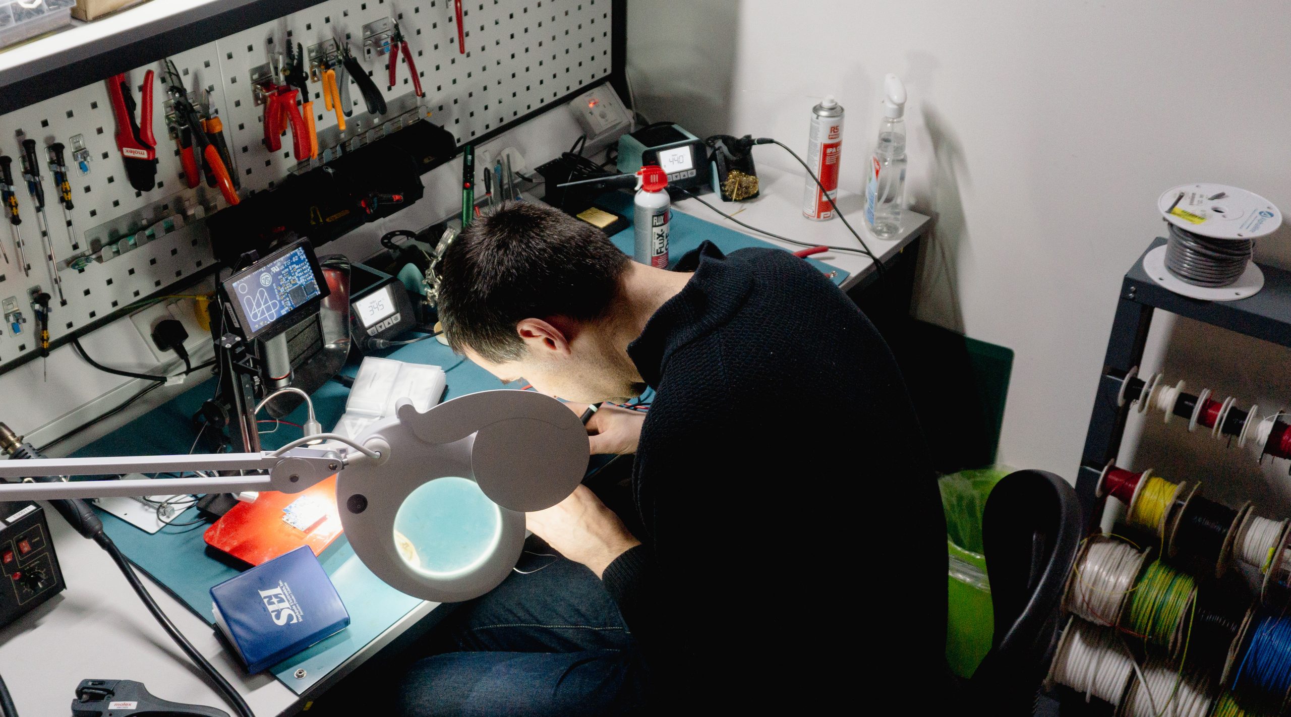 electronics engineer soldering on i4PD lab - electronics product design